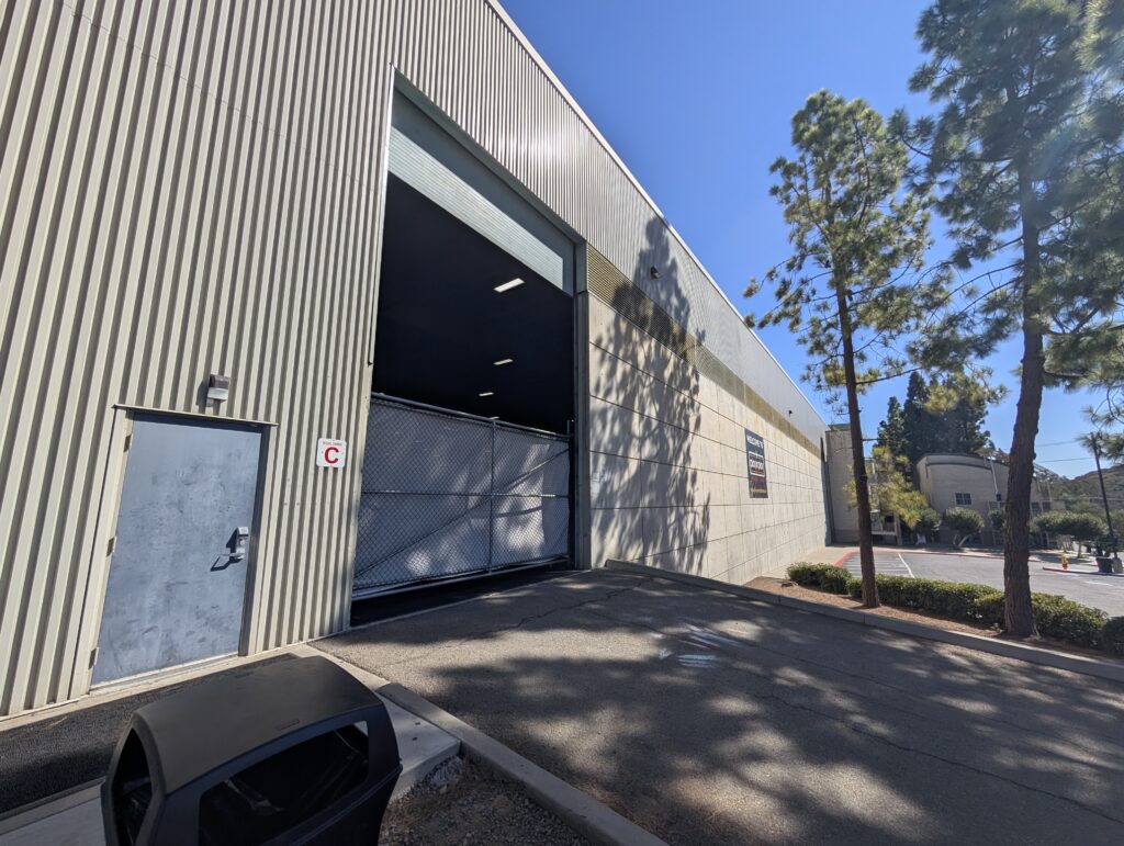 Building entrance door beside the large roll-up door