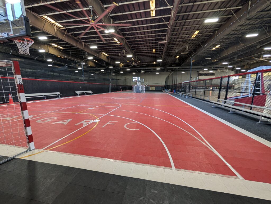 Sport court with futsal goal and basketball hoops